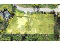 An aerial view of property lines showcasing land features, property dimensions, and nearby trees at 22435 Fortune Ave, Port Charlotte, FL 33954