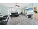 Modern living room featuring neutral-toned walls, wood floors, contemporary furniture, and lots of natural light at 22435 Fortune Ave, Port Charlotte, FL 33954