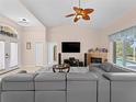 Open living room featuring high ceilings, cozy fireplace, tile floors and access to outdoor space at 2288 Prague Ln, Punta Gorda, FL 33983