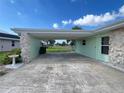 Attached carport with stone columns offers covered parking and protection from the elements at 2500 Aquilos Ct, Port Charlotte, FL 33952