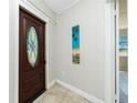 Welcoming foyer with an oval glass door, neutral walls, and tiled flooring at 31037 Prairie Creek Dr, Punta Gorda, FL 33982