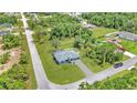 Drone image showing the property from above with landscaping, pool, lush trees and proximity to roads at 3104 Garbett Ter, North Port, FL 34288