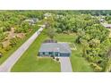 Aerial view of the property showcasing a well-maintained lawn, fenced pool and landscaping at 3104 Garbett Ter, North Port, FL 34288
