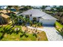 Stunning single-story home featuring a new metal roof, beautiful landscaping, and a paver driveway at 3520 Caya Largo Ct, Punta Gorda, FL 33950