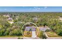 Expansive aerial view showcasing the property's location surrounded by lush greenery and neighborhood homes at 4129 Palisades Ave, North Port, FL 34287
