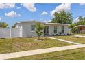 Inviting single-story home with a well-kept front yard and modern gray exterior paint at 6309 Pontiac Ln, North Port, FL 34287