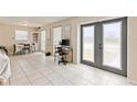 Bright and airy living room featuring tile floors and french doors with great lighting at 6309 Pontiac Ln, North Port, FL 34287