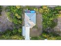 Aerial view of a home with a private backyard pool, surrounded by lush greenery and mature trees at 7122 Turner St, Englewood, FL 34224
