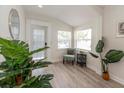 Sunlit entryway with modern decor and a charming chair, creating a warm welcome at 7413 S Elliott St, Tampa, FL 33616