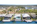 Waterfront home featuring a backyard pool and a boat dock, perfect for enjoying waterfront living and leisure at 8084 Burwell Cir, Port Charlotte, FL 33981