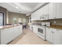 Well-lit kitchen boasting granite countertops, stainless steel appliances, and breakfast nook at 95 Vivante Blvd # 9524, Punta Gorda, FL 33950