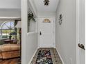 Inviting entryway with decorative tile flooring, a stylish front door, and a glimpse into the living area at 1372 Annette St, Punta Gorda, FL 33980