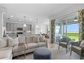 Bright living room featuring comfortable seating, sliding glass doors, and seamless flow to the kitchen at 14061 Heritage Landing Blvd # 445, Punta Gorda, FL 33955