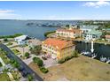 Aerial shot showcasing the charming yellow townhouse with a dock and waterfront access at 1410 Park Beach Cir # 113, Punta Gorda, FL 33950