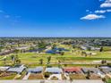 Aerial view of a residential community with a golf course, showcasing the property's location and surrounding neighborhood at 142 Rotonda Cir, Rotonda West, FL 33947