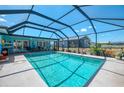 Screened-in pool area with clear blue water, offering a relaxing outdoor space with views of the backyard at 142 Rotonda Cir, Rotonda West, FL 33947