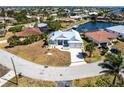 Beautiful waterfront home with a metal roof, lush greenery, and a private canal at 1711 Boca Raton Ct, Punta Gorda, FL 33950