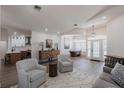 Spacious living room with wood floors, stylish furniture, and an open floor plan at 1711 Boca Raton Ct, Punta Gorda, FL 33950