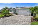 Charming single-story home with well-manicured lawn, lovely landscaping, and a paved driveway leading to a two-car garage at 17459 Palmetto Pass Ln, Punta Gorda, FL 33982