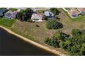 Aerial view of a home with a tile roof, expansive backyard, and waterfront access at 1856 Nuremberg Blvd, Punta Gorda, FL 33983