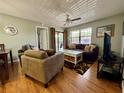 Comfortable living room with ceiling fan, ample natural light, and stylish decor at 19505 Quesada Ave # Ii201, Port Charlotte, FL 33948
