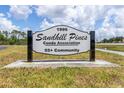 Sandhill Pines Condo Association sign at the entrance to this well-maintained 55+ community at 1999 Kings Hwy # 24C, Punta Gorda, FL 33980