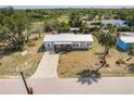Exterior aerial shot of a single Gathering home surrounded by lush landscaping at 200 Summerset Dr, Punta Gorda, FL 33982