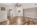Spacious living room with wood floors and an open view to the modern kitchen at 200 Summerset Dr, Punta Gorda, FL 33982