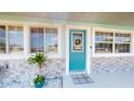 Welcoming front entry with attractive blue door, decorative wreath, and stone veneer accents at 20407 Albury Dr, Port Charlotte, FL 33952