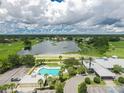 Stunning aerial view featuring a community pool, beautiful lake, and golf course at 2087 Lynx Run, North Port, FL 34288