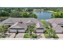 Breathtaking aerial view of the property showcasing the tile roof, landscaping, and serene water views at 2087 Lynx Run, North Port, FL 34288