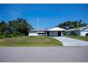 Charming single-story home featuring a carport and a concrete driveway at 2113 Barksdale St, Port Charlotte, FL 33948