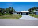 Charming single-story home featuring a carport and a concrete driveway at 2113 Barksdale St, Port Charlotte, FL 33948