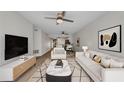 Cozy living room features stylish decor, comfortable seating, with view to the dining area and kitchen at 23465 Harborview Rd # 1002, Punta Gorda, FL 33980