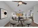 Bright living and dining area with neutral tones, modern furnishings, and view of bedroom and sliding glass doors at 23465 Harborview Rd # 1002, Punta Gorda, FL 33980