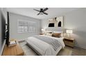 Comfortable main bedroom with modern decor, neutral color palette, and bright window at 23465 Harborview Rd # 1002, Punta Gorda, FL 33980