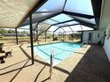Beautiful screened-in pool with clear blue water, offering a serene outdoor retreat at 261 Caddy Rd, Rotonda West, FL 33947
