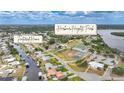 An aerial view features a waterfront home close to Harbour Heights Park with tennis and shuffleboard courts at 27385 Voyageur Dr, Punta Gorda, FL 33983