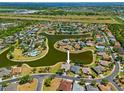 Aerial view of a neighborhood featuring ponds and well-manicured lawns at 2871 Suncoast Lakes Blvd, Punta Gorda, FL 33980