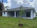 This covered patio has a pair of sliding doors providing a seamless indoor/outdoor living experience at 298 Overbrook St, Port Charlotte, FL 33954