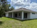 The home has a covered patio and a grassy backyard at 384 Prineville St, Port Charlotte, FL 33954
