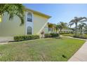 Building 2, shows corner unit with healthy green lawn and vegetation at 4000 E Bal Harbor Blvd. E. #211 # 211, Punta Gorda, FL 33950