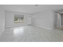 Bright living room featuring new flooring, fresh paint, and ample natural light from a large window at 4243 Hokan Ave, North Port, FL 34287