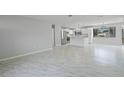 Open-concept living area with modern flooring, connecting seamlessly to a stylish, updated kitchen at 4243 Hokan Ave, North Port, FL 34287