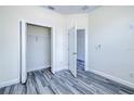 A bright bedroom featuring a closet, base trim, modern flooring, and ample electrical outlets at 4285 Oak Terrace Cir, Port Charlotte, FL 33953