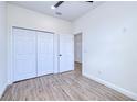 This bedroom offers light woodgrain flooring, closet and bright white walls at 4290 Oak Terrace Cir, Port Charlotte, FL 33953