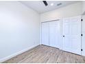 Clean bedroom featuring a ceiling fan, light woodgrain flooring and a spacious closet at 4290 Oak Terrace Cir, Port Charlotte, FL 33953