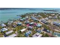 Aerial view highlighting the location of the beach home within a vibrant coastal community near the Gulf at 9390 Little Gasparilla Island, Placida, FL 33946
