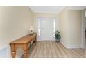 Bright entryway featuring a wooden console table, decorative lamp, and stylish flooring at 101 N Marion Ct # 215, Punta Gorda, FL 33950