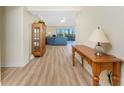 Inviting living room with hardwood floors, cabinet, and sliding doors to balcony at 101 N Marion Ct # 215, Punta Gorda, FL 33950